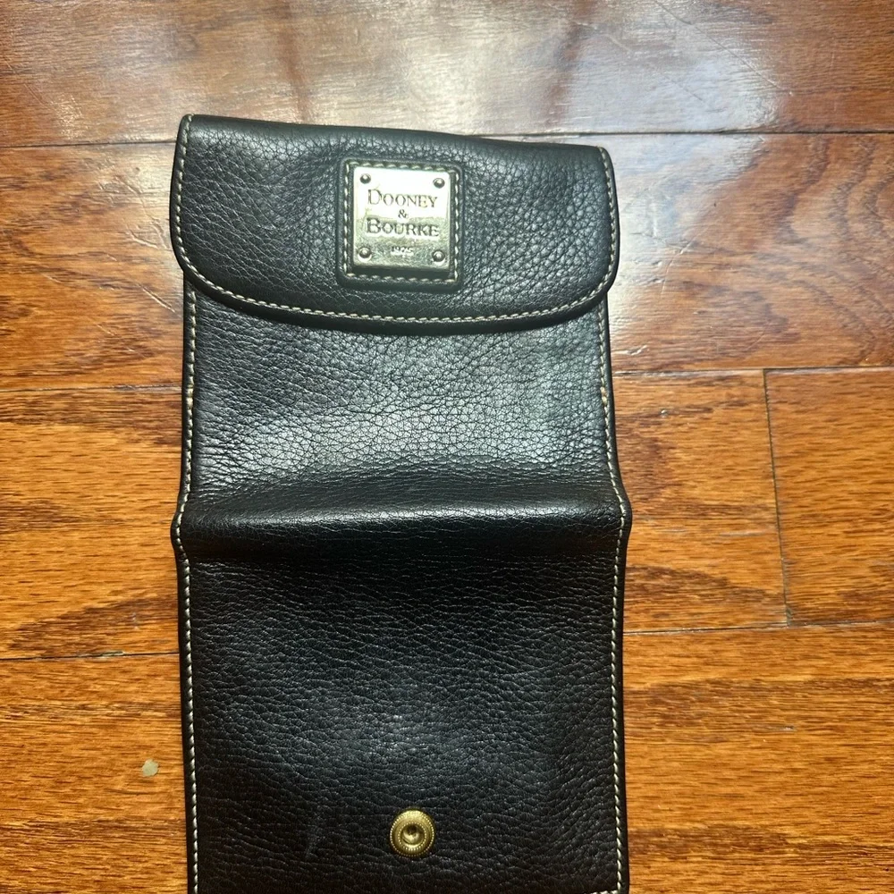 Dooney & Bourke pebble grain flap wallet a metal logo plate & contrast stitching